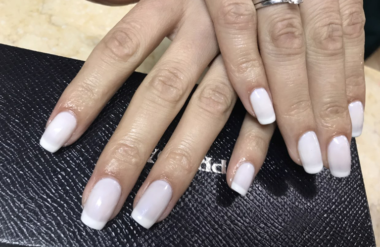 White manicure with gold glitter accent nail